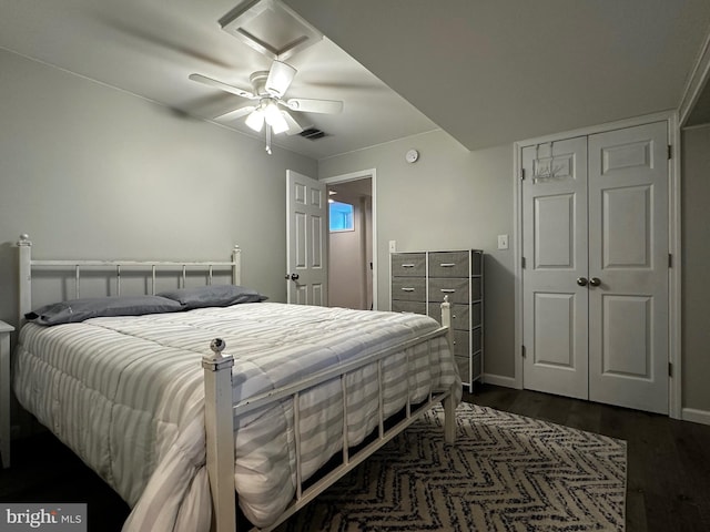 bedroom with visible vents, baseboards, ceiling fan, a closet, and dark wood-style floors