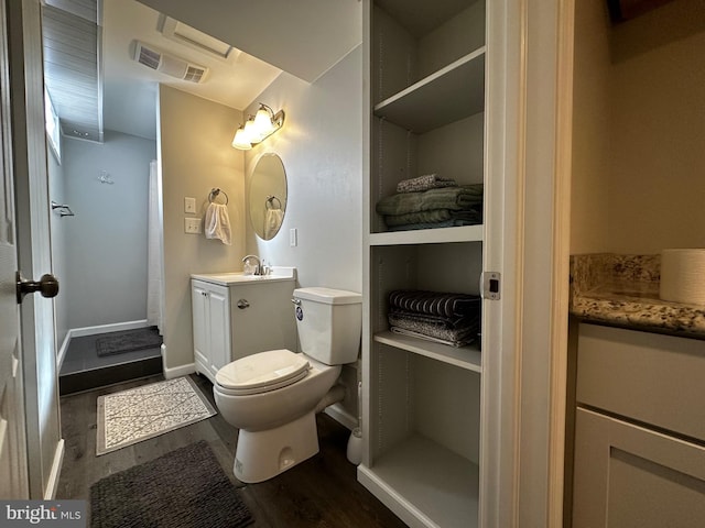 full bathroom featuring visible vents, toilet, wood finished floors, baseboards, and vanity