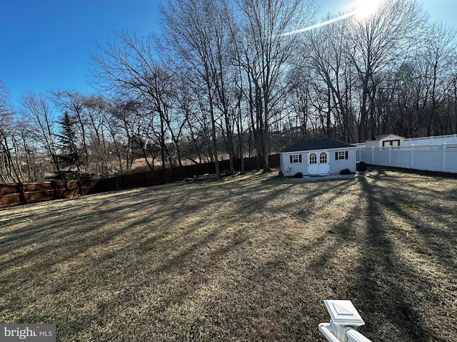 view of yard with an outbuilding and a fenced backyard