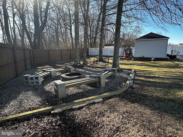 view of yard featuring a storage shed, an outbuilding, and a fenced backyard