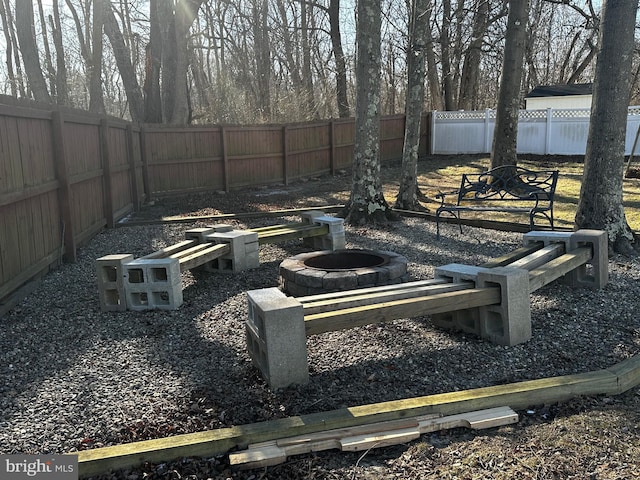 view of yard featuring a fenced backyard and an outdoor fire pit