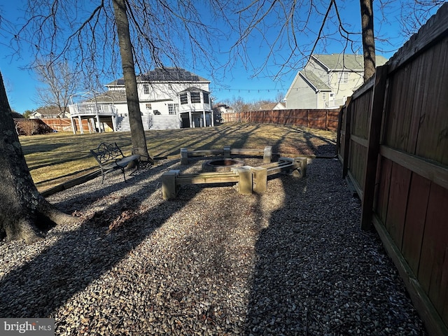 view of yard with a fire pit and a fenced backyard