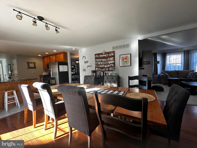 dining room with light wood-style flooring and visible vents