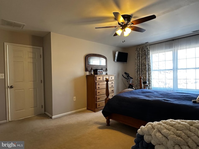 bedroom featuring visible vents, light carpet, baseboards, and ceiling fan