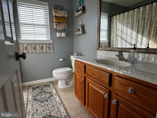 full bathroom with vanity, tile patterned floors, toilet, and baseboards