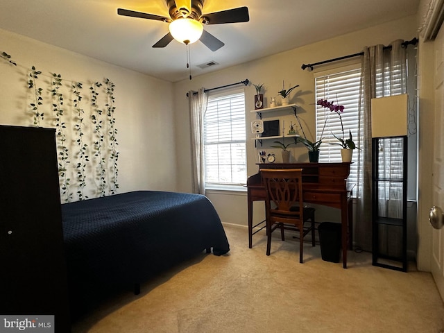 bedroom with visible vents, a ceiling fan, and carpet