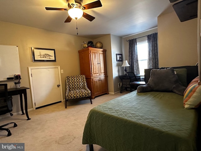 bedroom with ceiling fan, baseboards, and light carpet