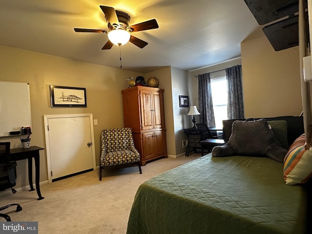 bedroom with a ceiling fan, baseboards, and light carpet