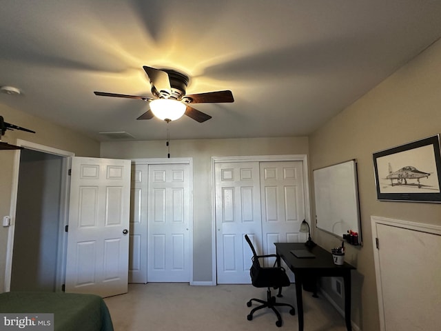 office space with light carpet and ceiling fan