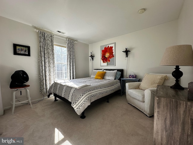 bedroom featuring light colored carpet and visible vents