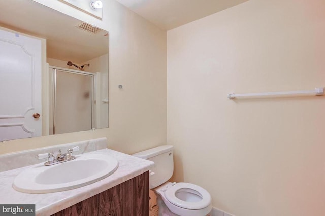 bathroom featuring visible vents, toilet, a stall shower, and vanity