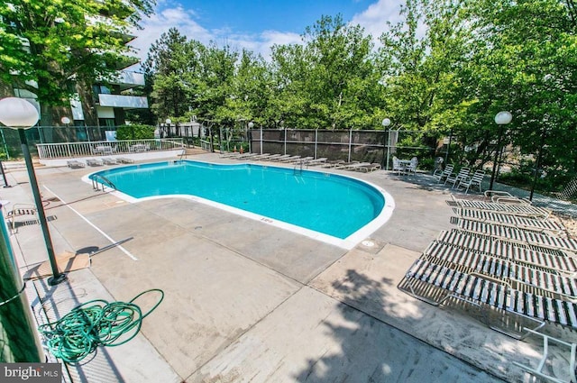 pool featuring a patio area and fence