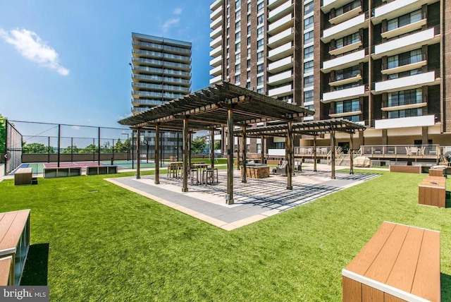 view of home's community with a yard, a pergola, and fence