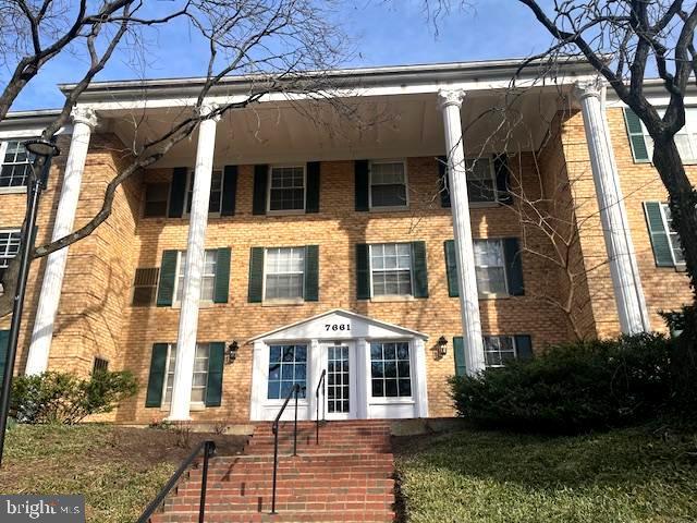 neoclassical home with brick siding