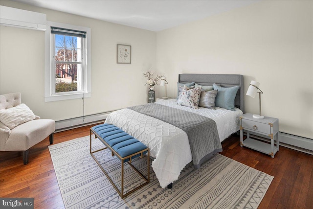 bedroom featuring baseboard heating, an AC wall unit, and hardwood / wood-style floors