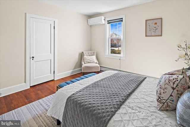 bedroom with baseboards, a wall unit AC, and hardwood / wood-style floors