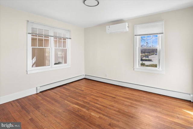 unfurnished room with an AC wall unit, baseboards, wood-type flooring, and a baseboard radiator