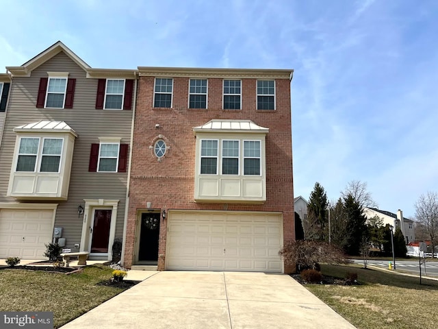 townhome / multi-family property with brick siding, a garage, and driveway