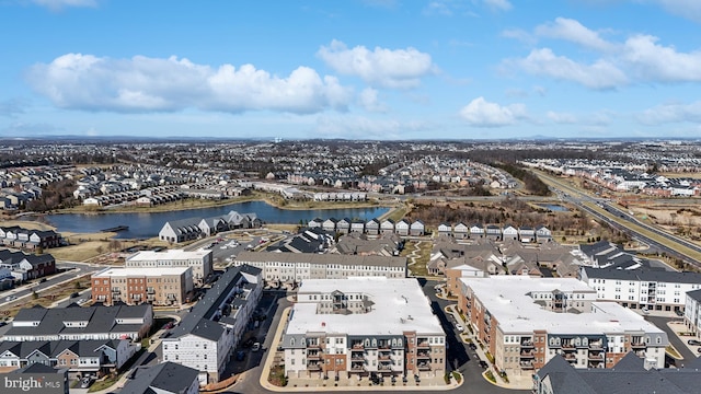 drone / aerial view featuring a residential view and a water view