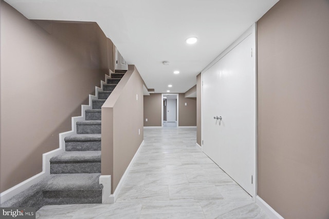 hallway with stairway, recessed lighting, and baseboards