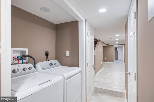 clothes washing area featuring washing machine and clothes dryer, laundry area, and recessed lighting