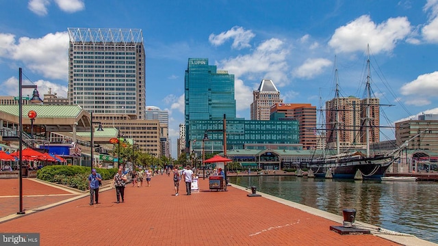 exterior space with a city view and a water view