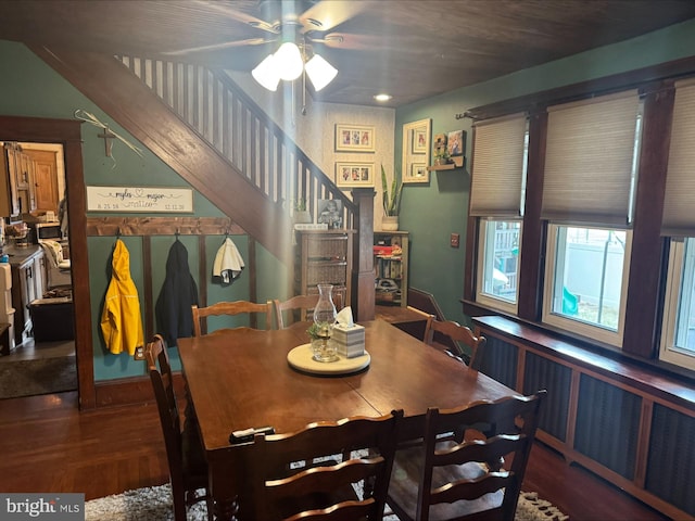 dining room with stairs, ceiling fan, and wood finished floors