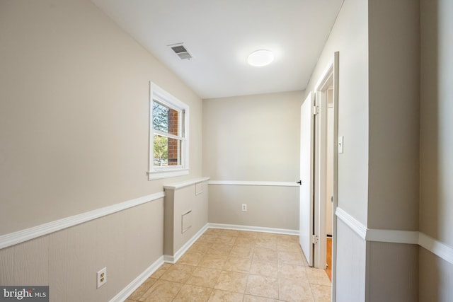 corridor with visible vents and wainscoting