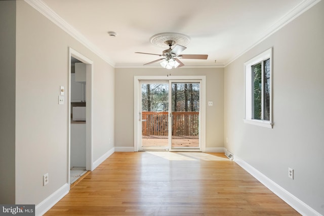 empty room with a ceiling fan, light wood finished floors, and ornamental molding