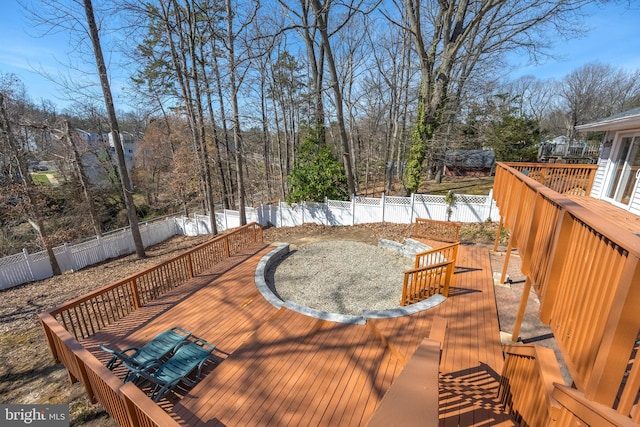 wooden deck with a fenced backyard