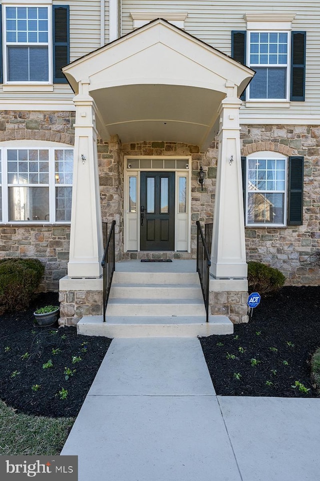 entrance to property featuring stone siding