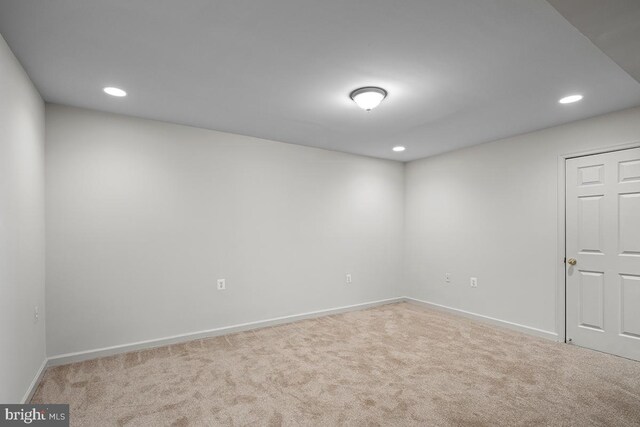 carpeted spare room featuring recessed lighting and baseboards