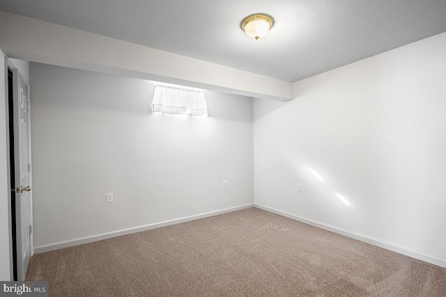 finished basement featuring baseboards and carpet