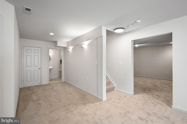 basement with visible vents, carpet floors, baseboards, and stairs