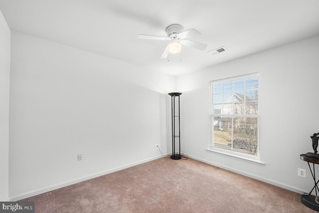 empty room with a ceiling fan, carpet, visible vents, and baseboards