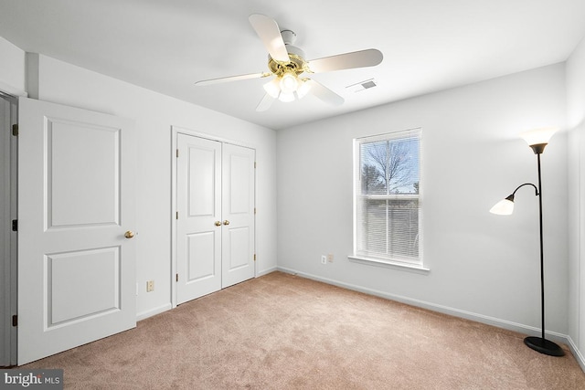 unfurnished bedroom featuring visible vents, baseboards, and carpet