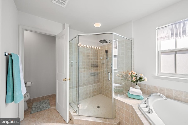 bathroom featuring tile patterned flooring, a shower stall, toilet, and visible vents