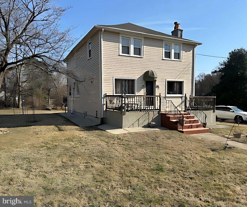 view of front of property featuring a wooden deck and a chimney