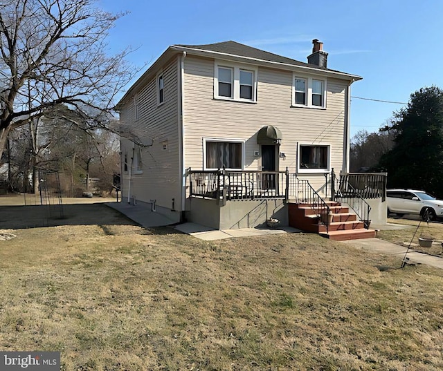 view of front of property featuring a wooden deck and a chimney