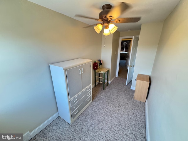 hallway with light colored carpet and baseboards