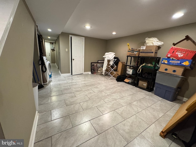 below grade area with tile patterned floors, recessed lighting, washer / dryer, and baseboards