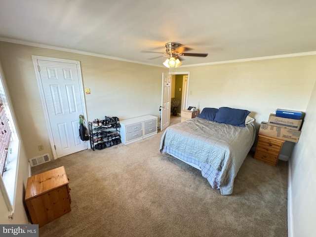 bedroom with crown molding, carpet flooring, visible vents, and ceiling fan