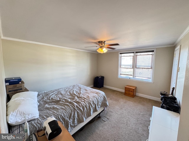 carpeted bedroom featuring a ceiling fan, baseboards, and ornamental molding