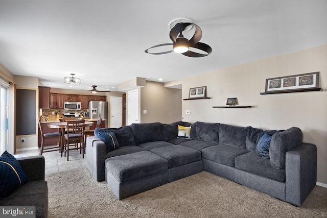 living room with light carpet and a ceiling fan