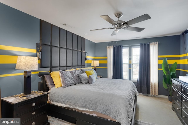 bedroom with a ceiling fan, light colored carpet, and visible vents