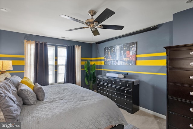 bedroom featuring carpet flooring, visible vents, a ceiling fan, and baseboards