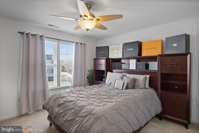 bedroom featuring visible vents, baseboards, ceiling fan, and carpet flooring