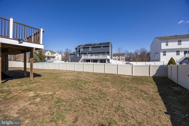 view of yard featuring a fenced backyard and a residential view