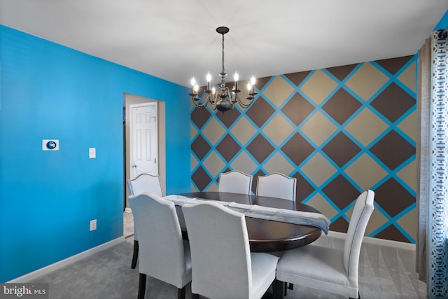 unfurnished dining area featuring wallpapered walls, an accent wall, baseboards, carpet floors, and an inviting chandelier