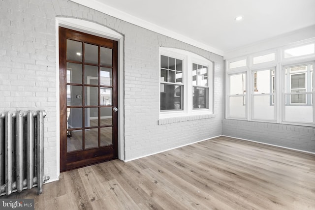 unfurnished sunroom with radiator